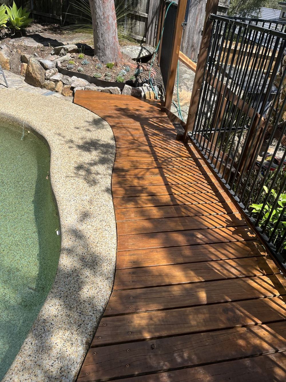 The same pool deck sanded and restained a rich brown