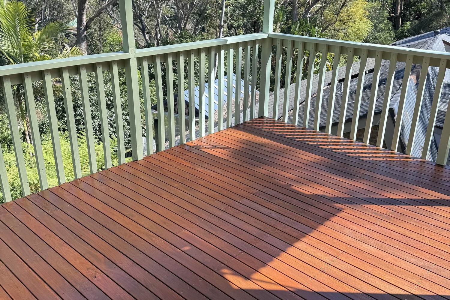 A Mount Colah deck restored from weathered grey to warm timber, with the balustrade repaired and repainted