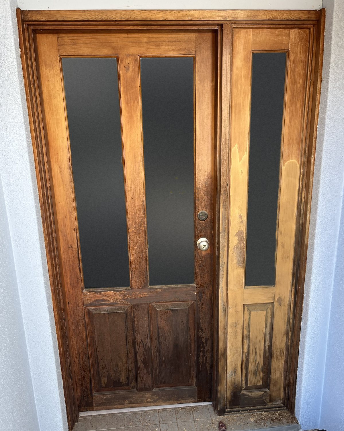 Sun-crazed, peeling front door and sidelight in Collaroy