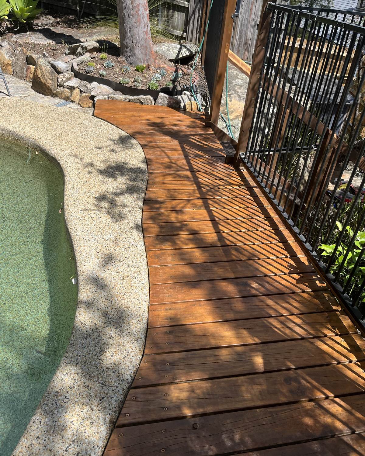 The same Mount Colah pool deck sanded back and restained a rich, even brown
