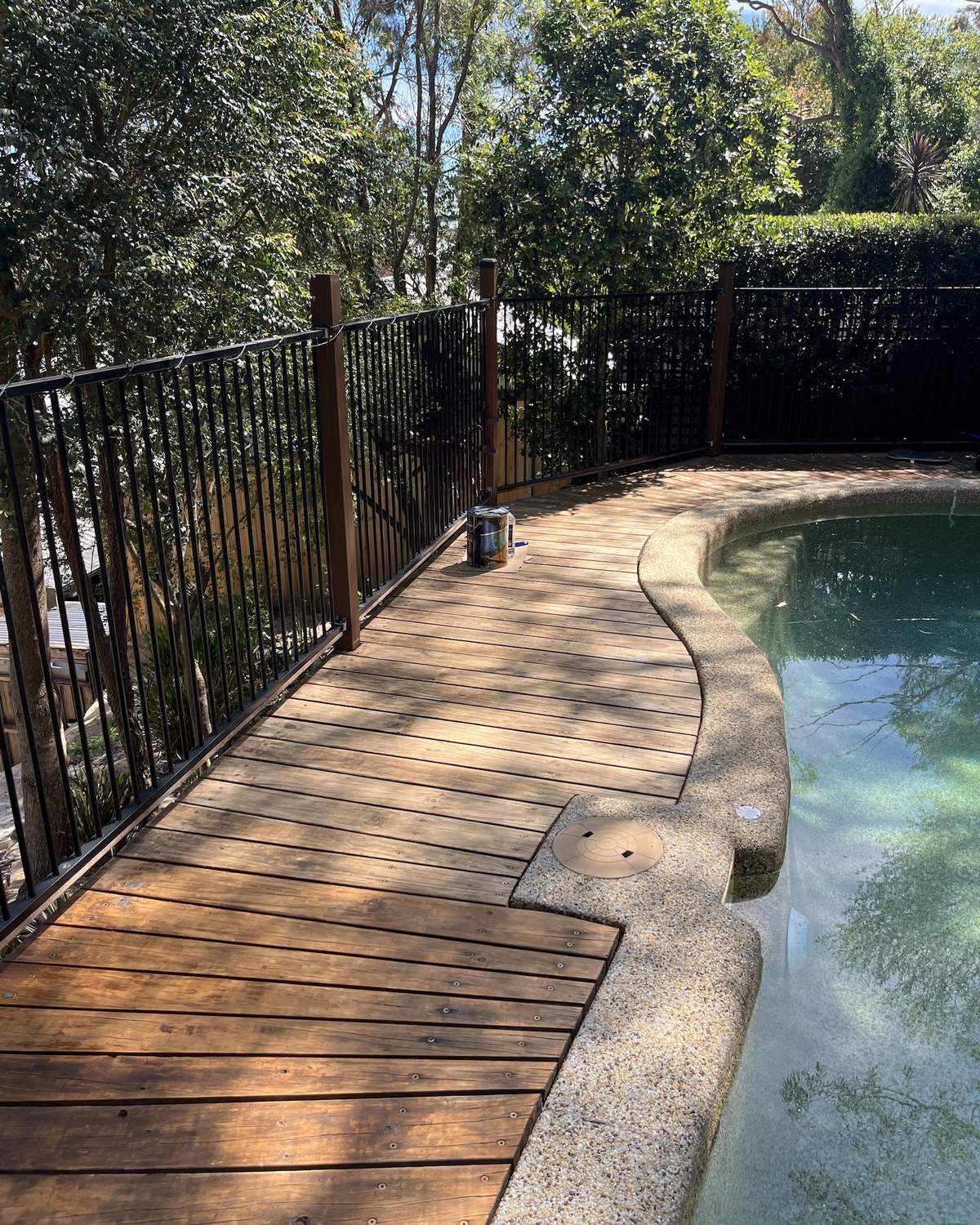 Faded, weathered timber pool deck along the pool fence in Mount Colah before restaining
