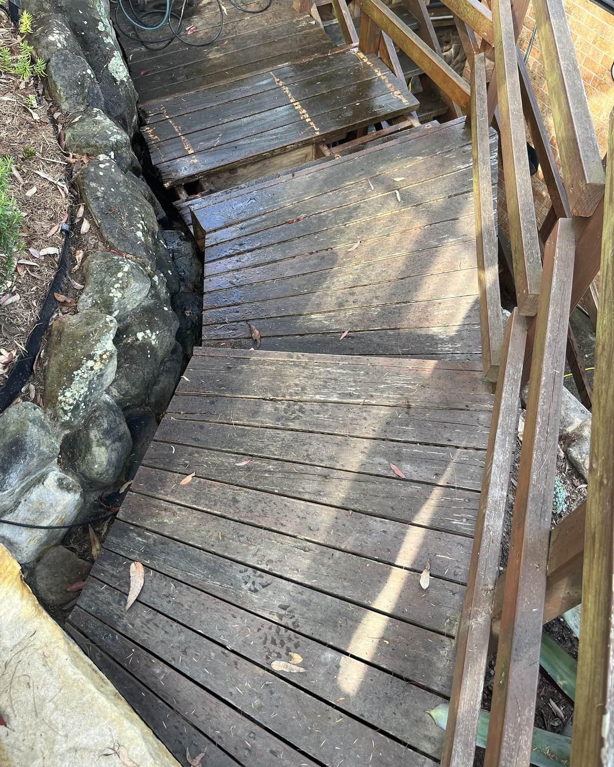 Rotten stair treads seen from the top of the flight, before repair